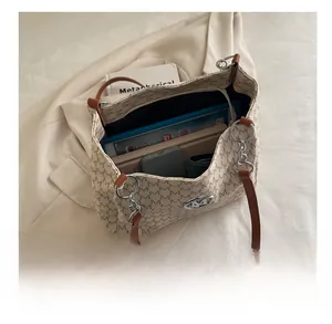 Detail showing the large interior capacity of the printed tote bag with daily items