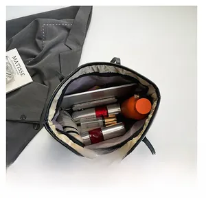 Macro view of large black tote bag interior showing purple lining and spacious storage