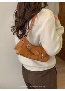 Chic brown leather underarm bag with silver buckles and retro teddy bear patch detail