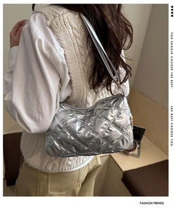 Close-up of silver quilted bubble shoulder bag on model with premium metallic finish