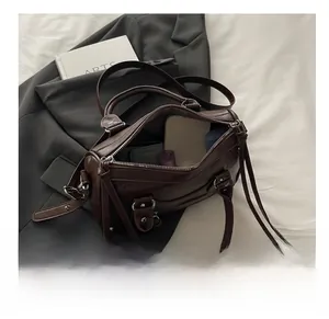 Deep brown Boston bag showing spacious interior with phone and essentials