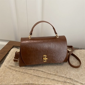 Classic vintage caramel leather handbag for women with gold clasp and top handle