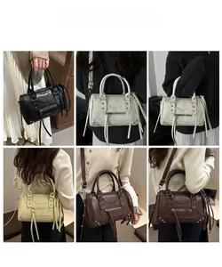 Detail view of rivet accents and long fringe zippers on colorful chic motorcycle handbags