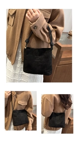 Macro shot of fashion and classic embossed text on black faux suede crossbody tote bag