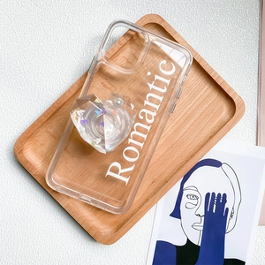Detail of transparent heart phone socket with sequins and Romantic text on case
