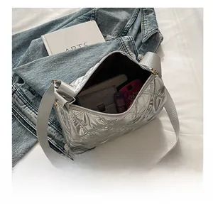Silver quilted nylon bag interior showing large capacity for phone and wallet