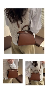 Detail of the golden twist lock and brown matte leather on the vintage trapezoid bag