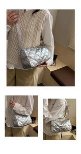 Close-up of silver quilted crossbody bag featuring high-quality metallic finish and texture