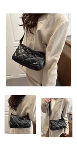 Detailed view of black quilted puffer crossbody bag with adjustable strap and gold zipper