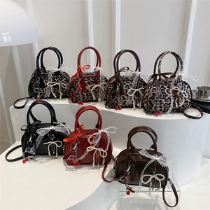 Minimalist pillow bags in leather and leopard print with lace bows and cherry charms
