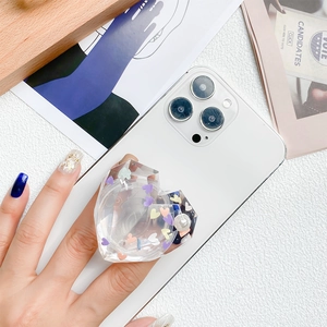 Transparent heart-shaped acrylic phone grip with colorful sequins and pearl accent