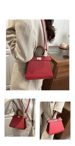 Detailed view of red leather tote bag with gold turn-lock and adjustable shoulder strap
