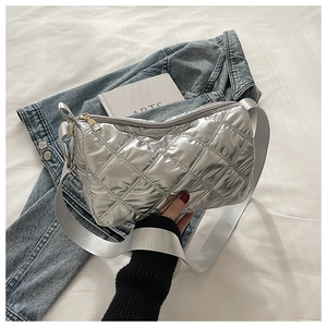 Close-up of silver quilted crossbody bag with grey wide strap and golden zipper detail