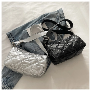 Detail of silver and black quilted tote bags with adjustable wide shoulder straps