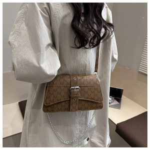 Detailed view of brown crossbody bag with letter print and silver chain strap