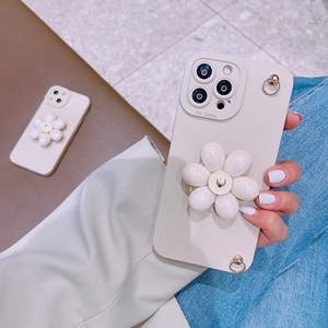 Detail of cream iPhone case with 3D white flower stand and integrated camera lens protection