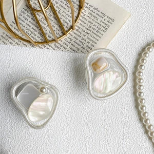 Close-up of pearl and marble pattern geometric phone grip with resin texture