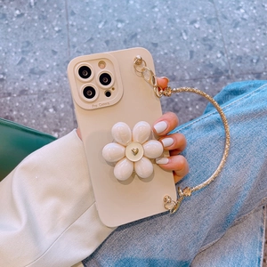 Detail view of 3D floral iPhone case with gold heart center and chic wrist chain