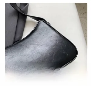 Macro detail of black textured leather handbag featuring silver JINFEI printed logo