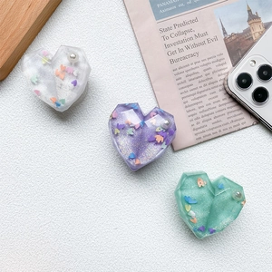 Detail of 3D heart phone grips with glitter sequins and pearls in multiple colors