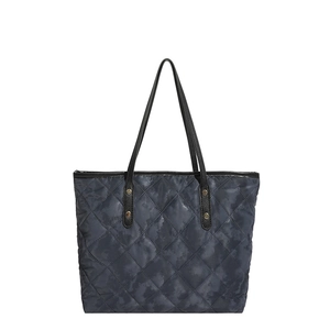 Sac fourre-tout matelassé avec motif losange et poignées en cuir sur fond blanc