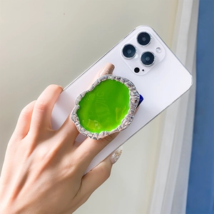 Detail view of the green irregular gemstone phone socket with a silver metallic finish
