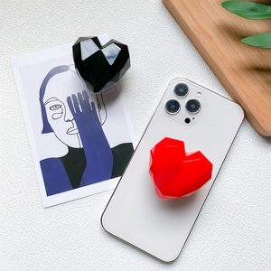 Minimalist geometric heart phone socket stand in glossy red and black finishes