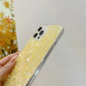 Detail of yellow glitter phone case featuring hexagon sequins and sparkling finish