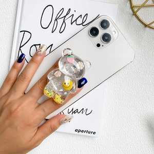 Clear bear phone socket with floral and glitter inserts on a white smartphone
