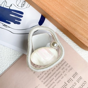 Detail of artistic phone socket with white faux pearl and iridescent marble shell inlay