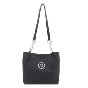 Vintage black tote bag with M-letter pattern and silver metal logo on white background