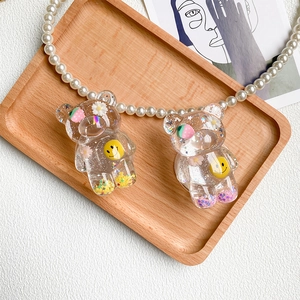 Close-up of cute bear phone grips with colorful sequins, flowers, and resin finish