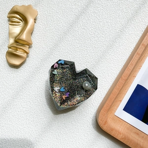 Detail of 3D heart phone socket with black glitter, colorful hearts and pearl inlay