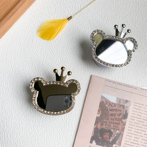 Macro detail of bear phone grip mirrors with rhinestone crowns in gold and silver finish