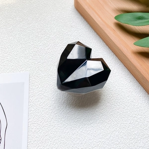 Detail of a 3D geometric heart phone socket with a polished black mirror finish