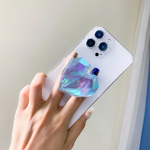 Handheld view of heart shaped laser iridescent cell phone grip stand on a phone case