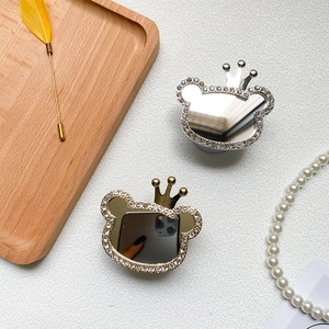 Detailed close-up of bear-shaped phone holders with rhinestones and mirrors