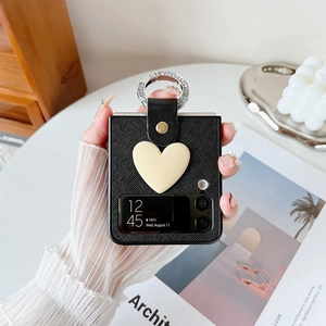 Detail of Galaxy Z Flip case with black texture, 3D heart, and diamond ring holder
