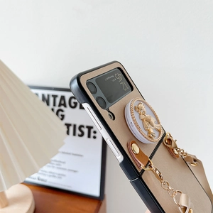 Detail of Galaxy Z Flip case with golden 3D bear stand and stylish chain strap