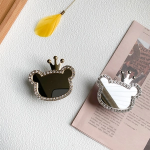 Close-up of rhinestone bear phone grips with gold and silver mirror finishes