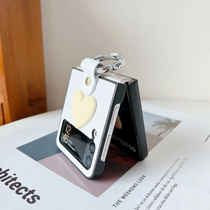 Detail of Samsung Z Flip3 case with 3D heart, leather texture, and metal ring strap