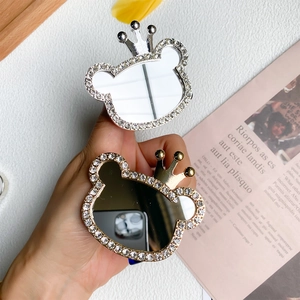 Sparkling rhinestone bear phone grip with crown and mirror, available in gold and silver