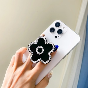 Elegant black five-petal flower phone socket with sparkling rhinestones on iPhone