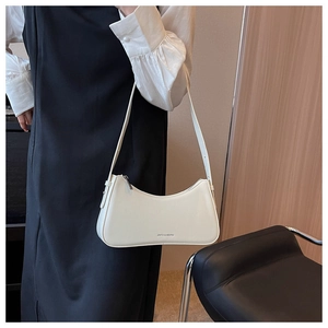 Detail of white leather shoulder bag with minimalist design and subtle brand lettering