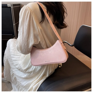 Detail view of pink crescent underarm bag with silver metal zipper and brand logo