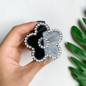 Close-up of luxury black floral phone socket grip with sparkling crystal rhinestones