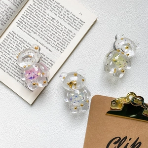 Detailed view of transparent resin bear phone grips with colorful glitters and Sweet text