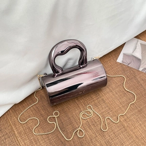 Modern cylinder handbag in gunmetal mirror finish with wave handle and gold chain