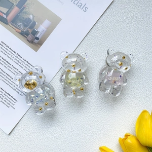 Close-up of three cute transparent resin bears with colorful sequins and Sweet text