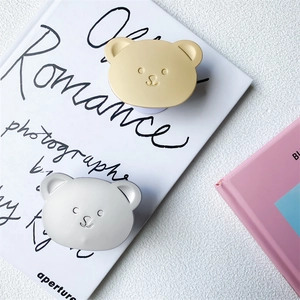Close-up of cute bear-shaped retractable phone sockets on a decorative art book